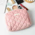 Detail of pink quilted corduroy makeup bag showing diamond stitching and spacious interior - Pink
