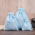 Set of three light blue drawstring linen pouches in different sizes for jewelry storage - Lake Blue