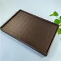Detailed top view of 100-slot brown wooden ring display tray with leather slots - Brown Brushed Leather