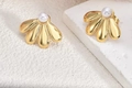 Golden flower petal earrings with white pearl center on a minimalist white stone background - ED09-Radiant Petal Pearl