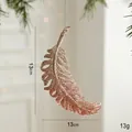 Champagne gold feather Christmas ornament with glitter finish and silver hanging string - Feather Style
