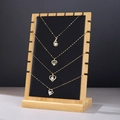 Bamboo wood jewelry display stand with four gold necklaces and heart-shaped pendants - ZM009 Medium Black PU Leather