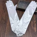 Close-up of long white satin wedding gloves with lace floral embroidery and pearl details - Long Hollow Sequin Beaded