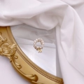 Detail of freshwater pearl beaded ring with a gold letter M charm on vintage mirror - Letter M