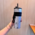 Blue stainless steel insulated bottle with black bow patterns, silicone sleeve, and strap - UV Printed Silver