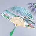 Chinese silk folding fan featuring lotus landscape pattern and green silk tassel - Summer Vibe