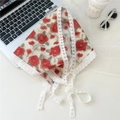 Red floral triangle headscarf with white lace trim and ties on a white desktop - Red Flower Beige Base
