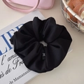 Oversized black satin scrunchie with minimalist woven label on artistic background - Matte Black
