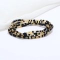 Detailed macro view of double-layered black and amber glass seed beads waist chain - 80cm / Black/Amber