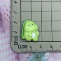 Macro shot of a 2.5cm green resin monster accessory with a ruler showing exact size - Style 3 / Right-facing Green Dinosaur