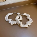 Detail view of white pleated satin hoop earrings on a vintage bronze jewelry tray - Satin Pleated (19#)