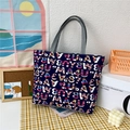 Artistic navy blue canvas tote bag with colorful abstract patterns and grey handles - Alphabet