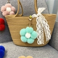 Cute mint green plush flower keychain hanging as a decorative charm on a straw bag - 1 Piece / Green