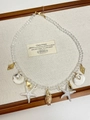 Detailed shot of ocean-themed necklace with crushed pink stones, shells and starfish charms - Starfish Conch Necklace Z-2702