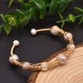 Handcrafted gold wire wrapped bangle featuring natural white and pink freshwater pearls - Gold Woven Winding Pearl Style