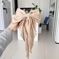 Champagne silk bow hair clip with long ribbons held to show draping and texture - Khaki