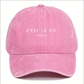 Close-up of pink baseball cap featuring white C'EST LA VIE PARIS embroidery detail - Pink