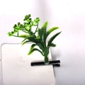 Detail of green sprout hair clip with black metal duckbill clip on white card display - Little Tree Style 3