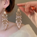 Close-up of vintage gold tassel earrings with pink beads worn by a model in warm light - 54# Hook-Pink