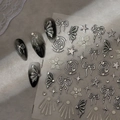 Pegatinas 3D plateadas para uñas con lazos y estrellas sobre mármol grisáceo - Estilo de Estrella con Lazo Plateado (CO-524)