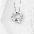Macro shot of polished silver balloon letter Q pendant with realistic knot detail - Letter Q Pendant
