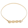 Macro detail of golden elastic metal belt featuring hollowed leaf-shaped buckle design - 4 Leaves