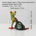 Creative green frog resin figurine holding a black money bag with a golden dollar sign - Money Bag Frog