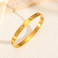 Luxury gold titanium steel star bangle with crystals on a textured white background - Star With Zirconia Style