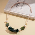 Detail of leather cord necklace with green marble beads and white pearls on a book - Green Marble (Necklace-Green)