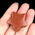 Handheld star-shaped gold sandstone crystal pendant with sparkling metallic brown finish - Gold Sand Stone (Synthetic)