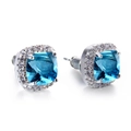 Macro shot of silver halo stud earrings with square blue gemstone and white zircon stones - Aqua
