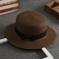 Brown straw beach hat for women with a black bow ribbon on a textured surface - One Size / Brown