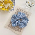Blue floral organza scrunchie with red and white flower patterns on vintage newspaper - Blue Daisy