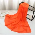 Elegant bright orange pearl chiffon scarf for women draped on a minimalist display stand - 175cmx70cm / Orange