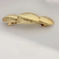 Elegant gold metal hair clip with triple brushed oval motifs and spring barrette closure - Ribbed Triple Oval Gold