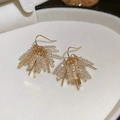 Macro detail of wheat ear crystal tassel earrings in a cream jewelry display box - 128 Ear Hooks - Gold