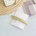 Polished gold geometric star spring clip with double-bar design on display card - Straight Gold