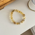 Macro detail of natural yellow agate beaded bracelet with gold hollow pendant charm - Citrine & Natural Stone Bracelet