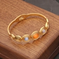 Detail of vintage gold bangle with cat eye stones and side hinge on wooden box - Multicolor Concentric Circle Style (2#)
