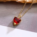 Close-up of red heart zircon pendant necklace in gold plating with elegant details - Red