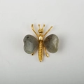 Elegant gold butterfly brooch featuring natural grey heart-shaped crystal wings - White Labradorite