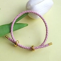 Adjustable pink braided leather bracelet with gold metal figure-eight buckle and charms - Pink