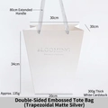 White trapezoid gift bag with 34cm height, long handles and embossed Blooming text - Double-sided Embossed Trapezoidal Matte Silver