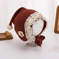 Detailed close-up of baby lace bonnet with floral applique and plush pom-pom decoration - 6-20 Months / Burgundy