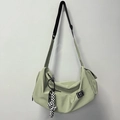 Light green crescent yoga bag with adjustable strap and checkered charm detail - Green + Knot