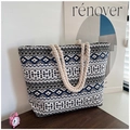 Detailed shot of ethnic geometric canvas tote bag with thick hemp rope handles on wood table - Blue White Ethnic Geometric