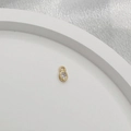 Close-up of a golden oval pendant with a faceted clear crystal for DIY jewelry - 925 Sterling Silver/Zirconia / Gold Oval Style