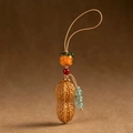Macro detail of sandalwood keychain featuring realistic peanut and persimmon charms - Good Things Happen Peanut Pendant