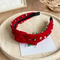 Close-up of red knotted velvet headband with colorful rhinestones and white pearls - Rhinestone Red