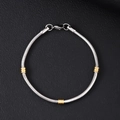 Close-up of Cuban chain bracelet with gold beads on black leather texture - 3.2mm Round Snake Chain With Gold Beads Bracelet